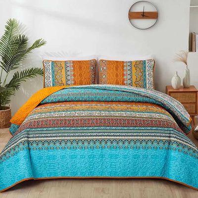 Bed with patterned quilt and pillows in a bedroom setting